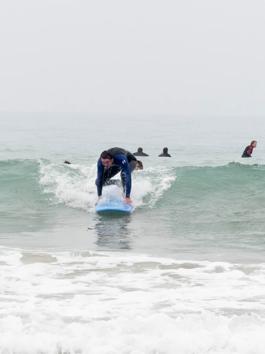 Surf student catching an open green wave