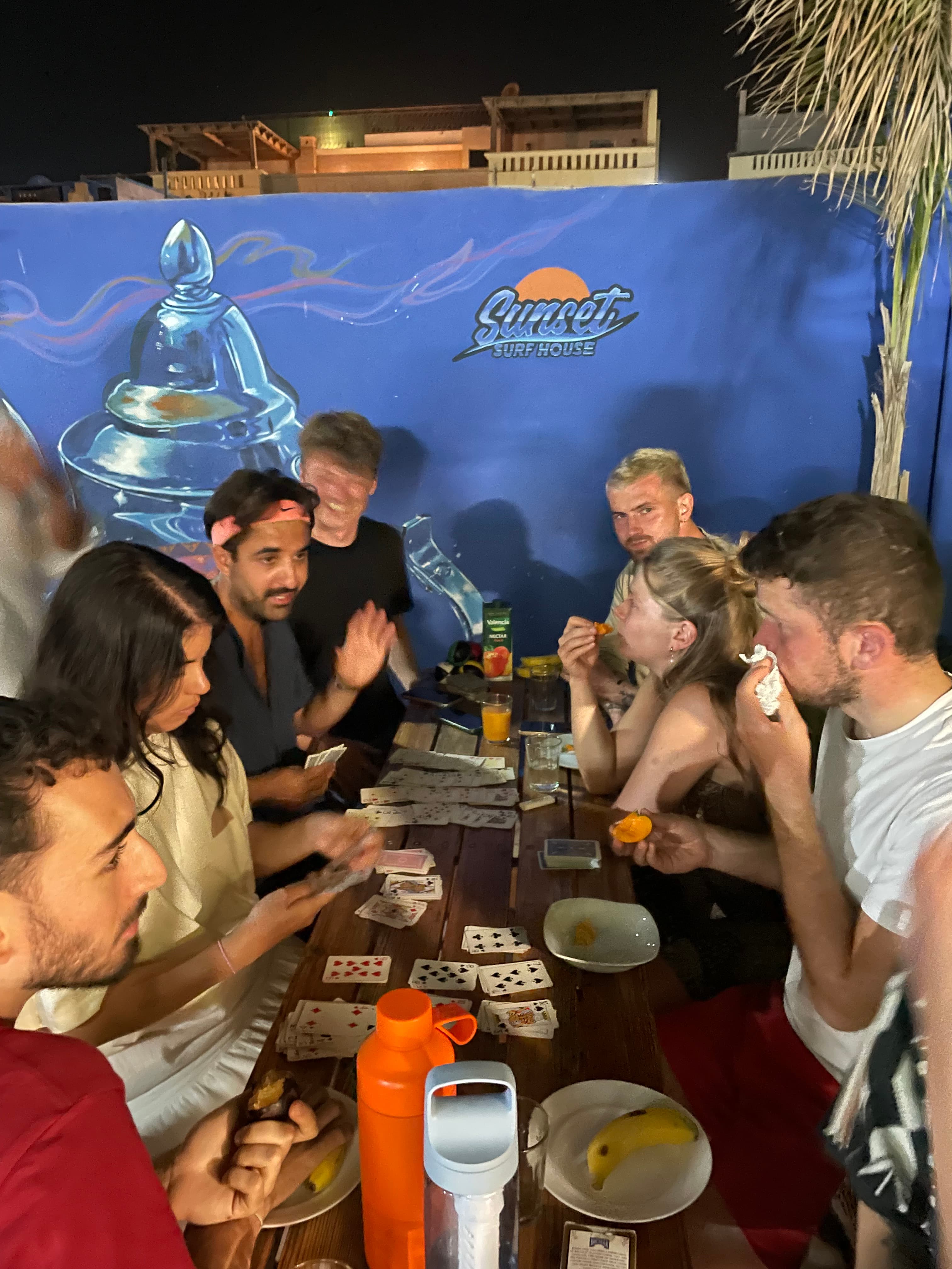 Guests sharing a Moroccan meal on the Sunset Surf House rooftop terrace