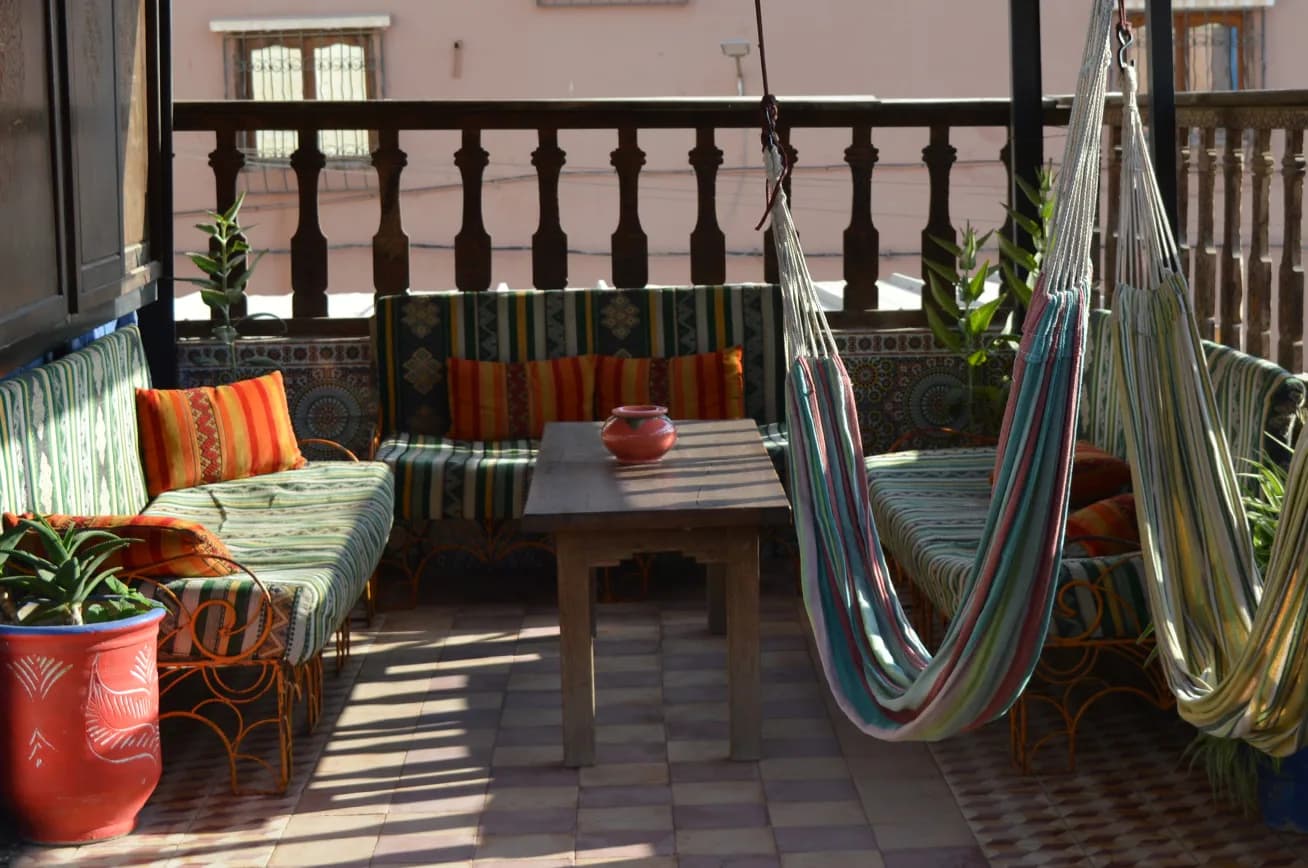 Guests sharing a Moroccan meal on the Sunset Surf House rooftop terrace