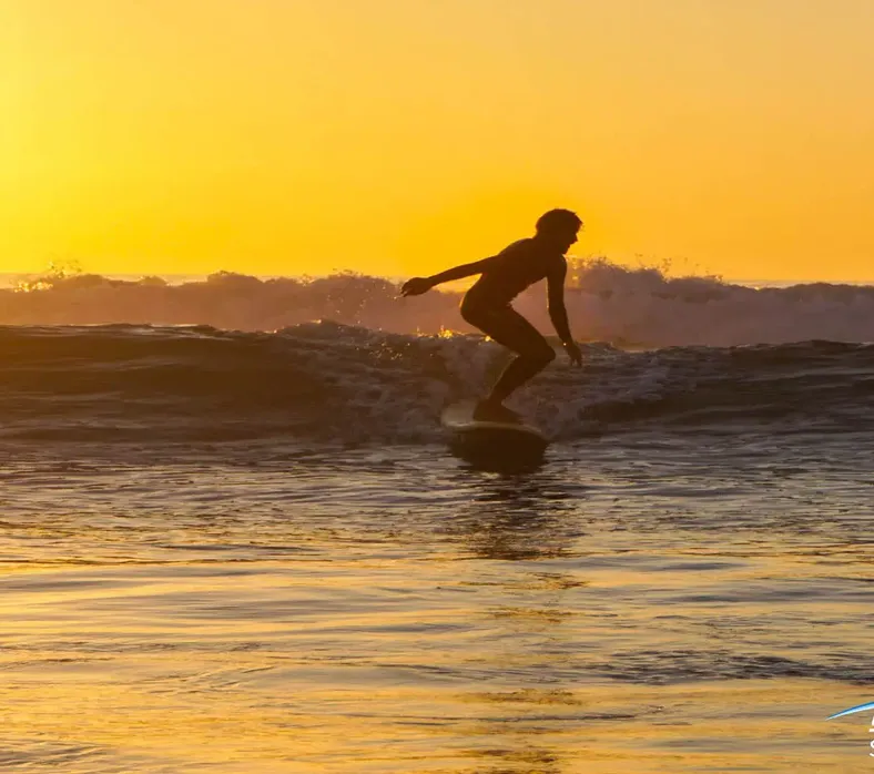 Golden evening light over the long beach at Crocro
