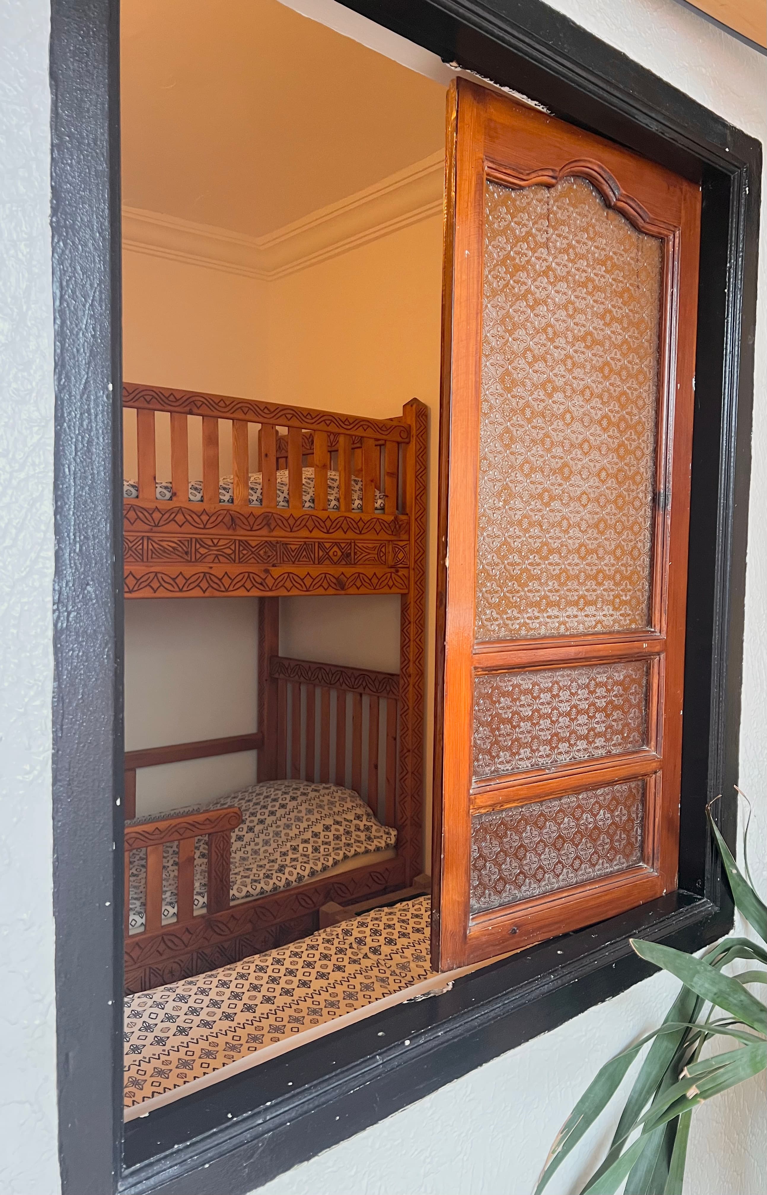 Sharing dorm room at Sunset Surf House with handcrafted wooden bunk beds and single bed